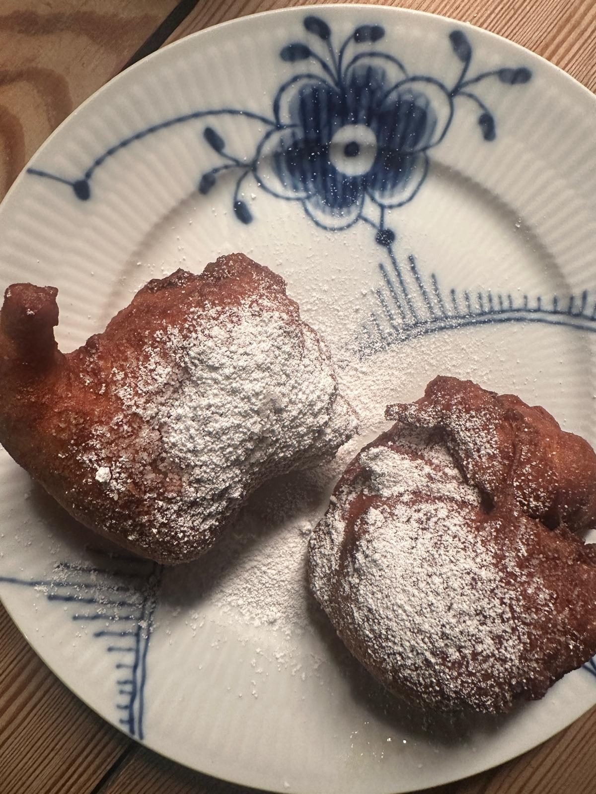 Zwei Ærø-Pfannkuchen mit Puderzucker auf einem blau gemusterten Porzellanteller